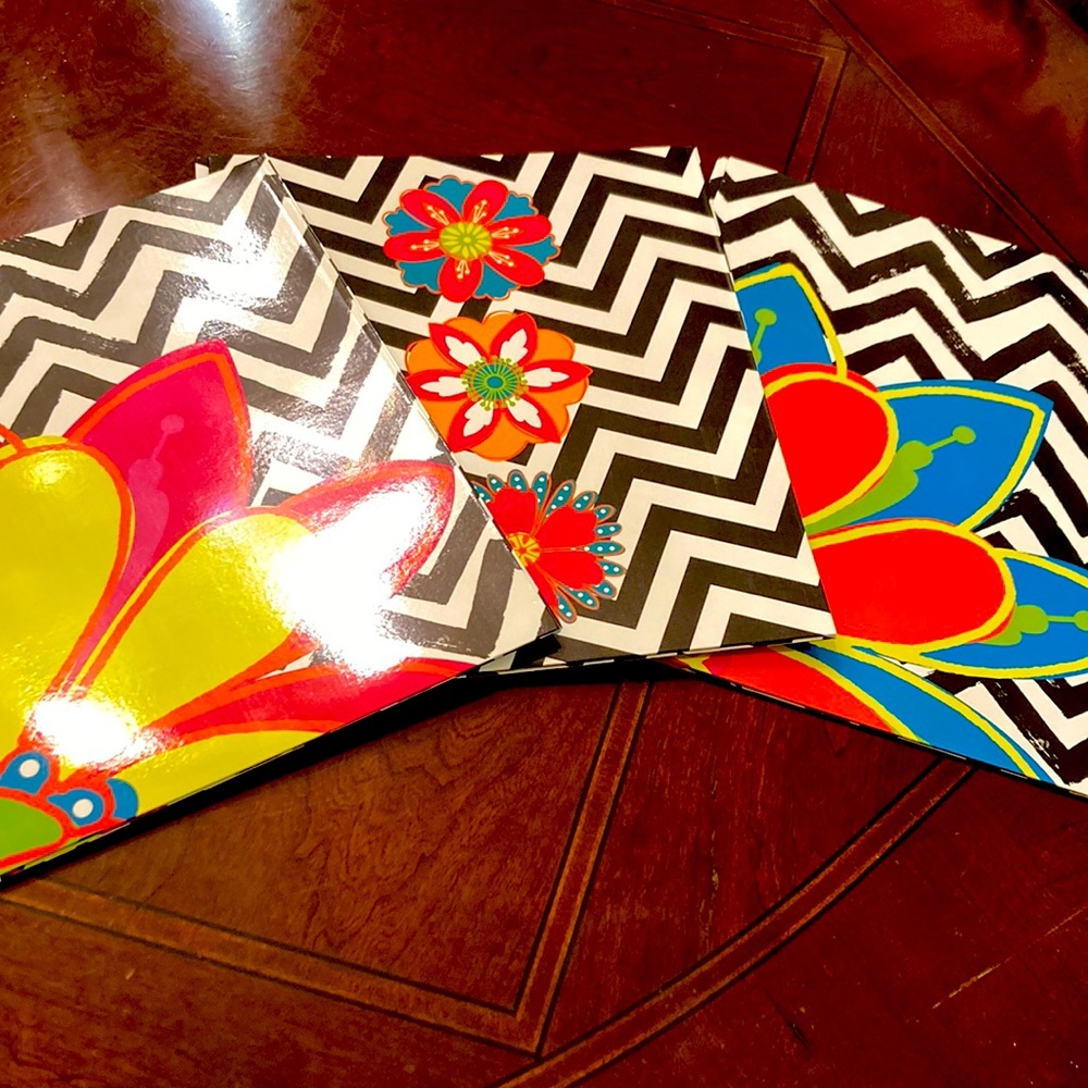 Set of three Unison two pocket floral printed folders.